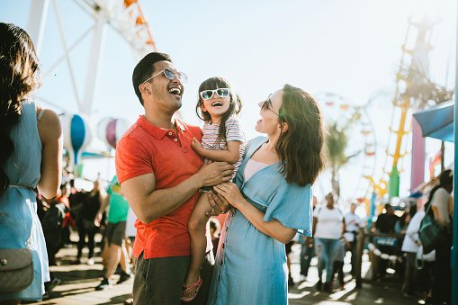 Family and child laughing at amusement park
